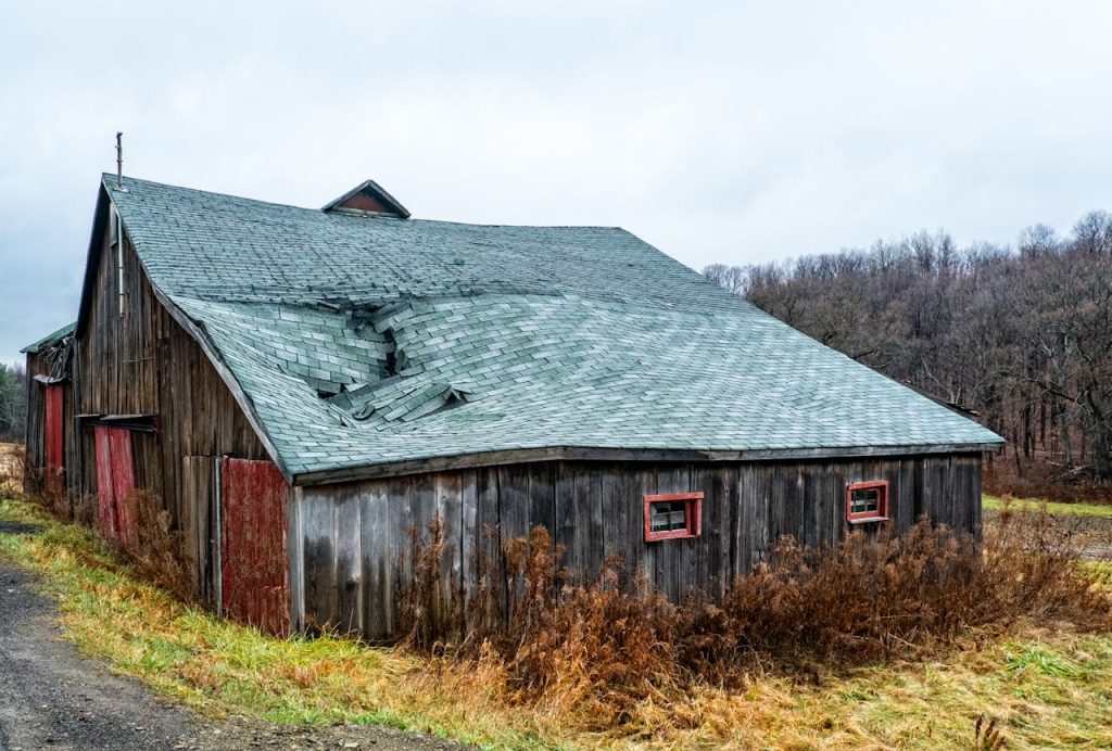 barn with storm-damaged roof